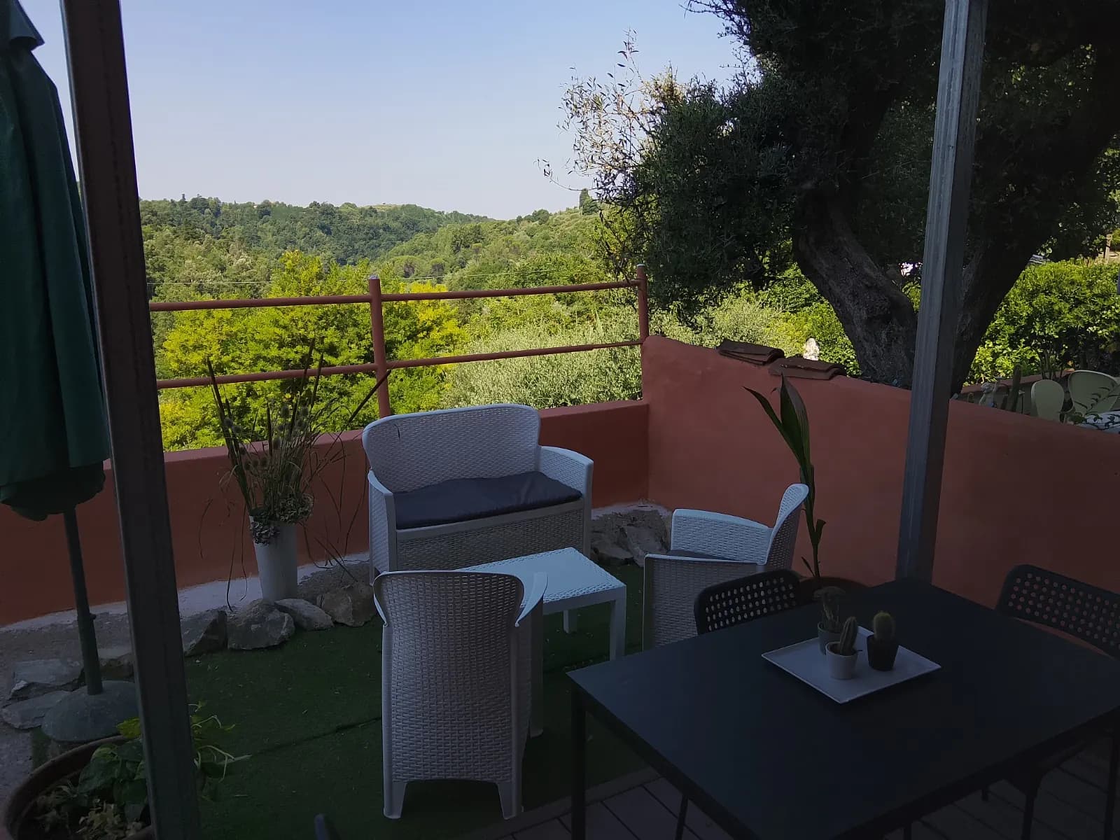 Terrace of Borgo Antico immersed in the green landscape of Montecastello